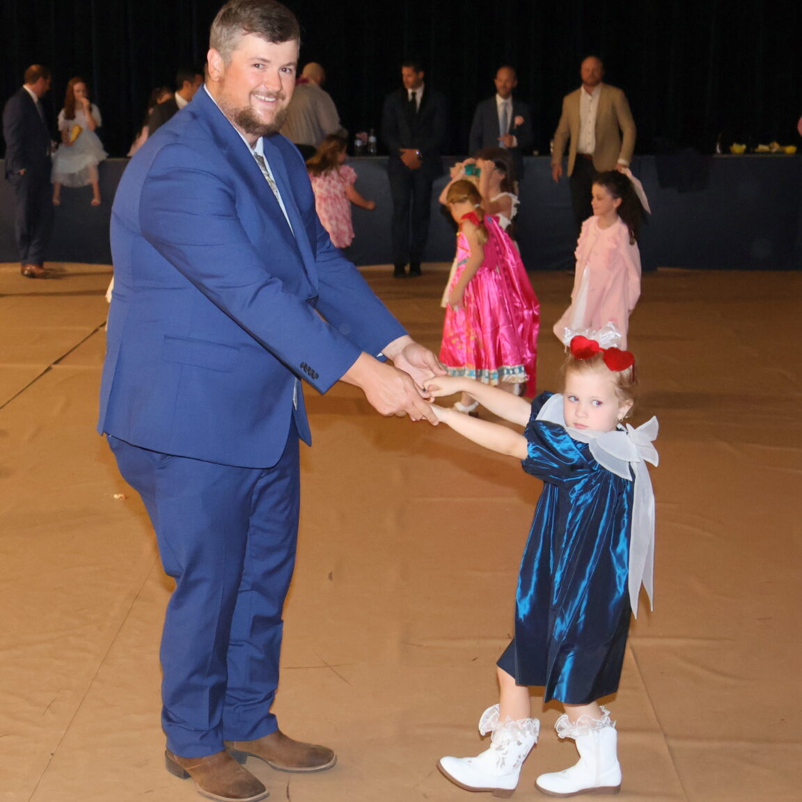 a father and daughter on the dance floor.