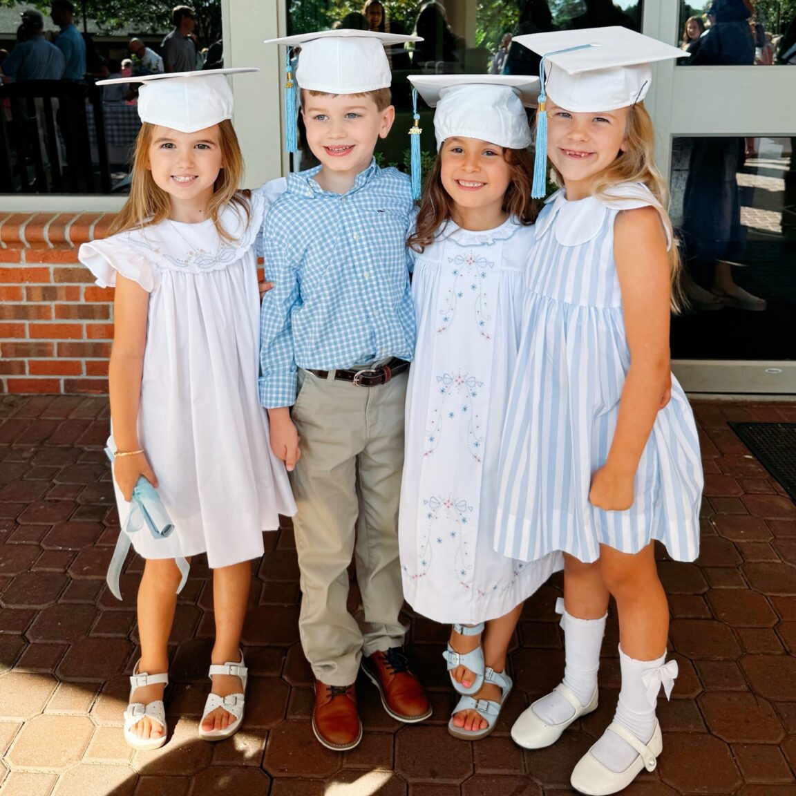 kindergarten students gathered in their graduation caps.