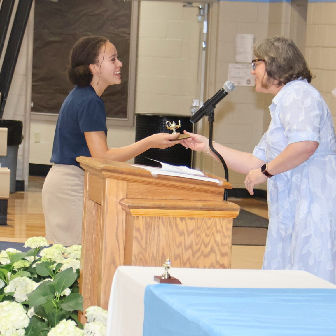 a student receiving an award at the upper school awards ceremony.